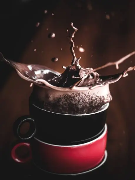 Coffee splash in a pile of cups.