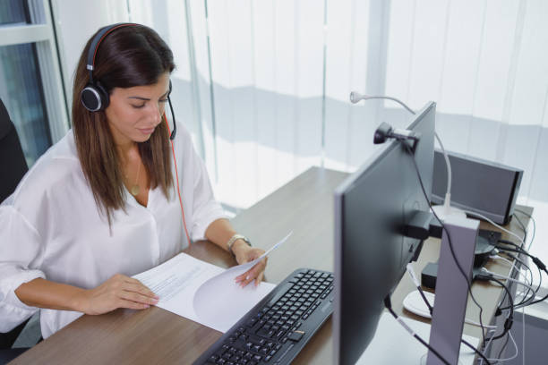 istock Woman checking documents and taking part in video call 1338040260
