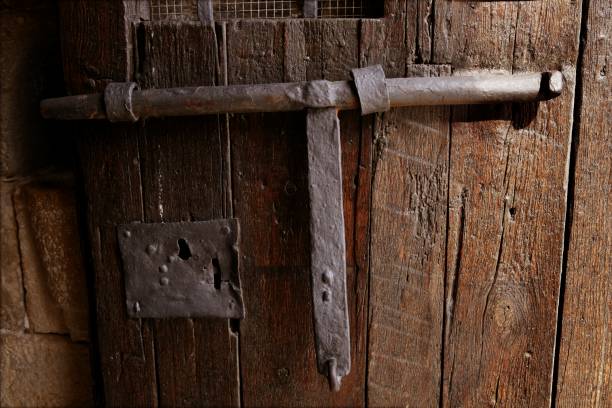 istock Old medieval lock on wooden castle door 1338042923