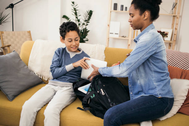 istock Schoolboy getting ready for school, assisted by his mom 1338044154