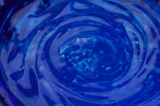 istock Pure transparent cosmetic gel on blue background, closeup 1338045082