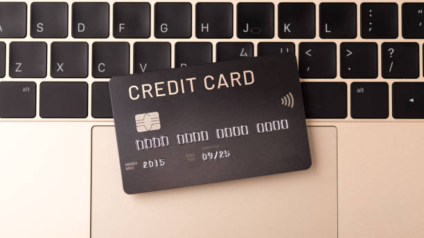 istock Credit card on gold laptop 1338050334