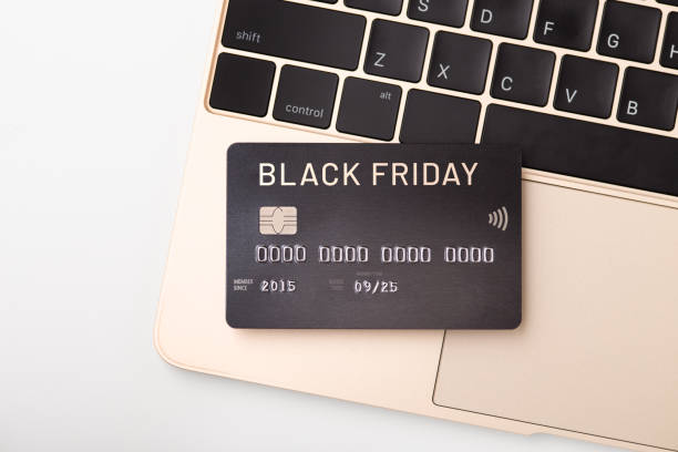 istock Black friday word on credit card on gold laptop 1338050355