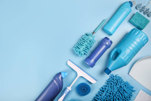 istock Blue cleaning supplies on blue background. Top view 1338053029