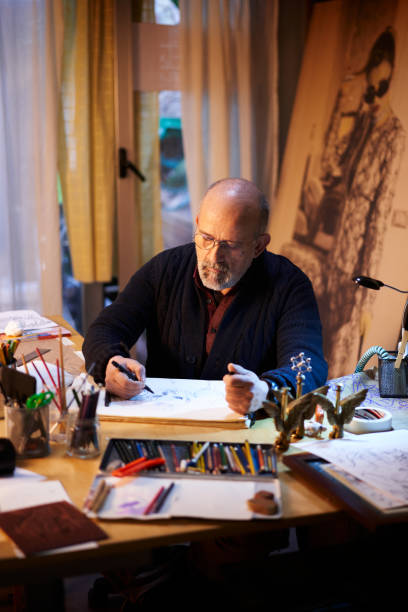 istock Artist working in the studio. Middle-aged man making creative artwork. 1338053303