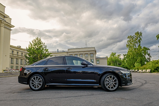 Saint Petersburg, Russia-On August 18, 2021, a black Audi A6 is parked in the city. Side view.