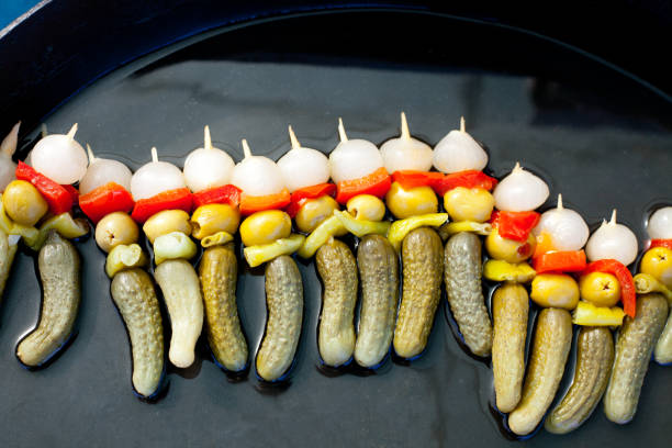 hot spicy appetizer in stick with pickles olives chili pepper and onion