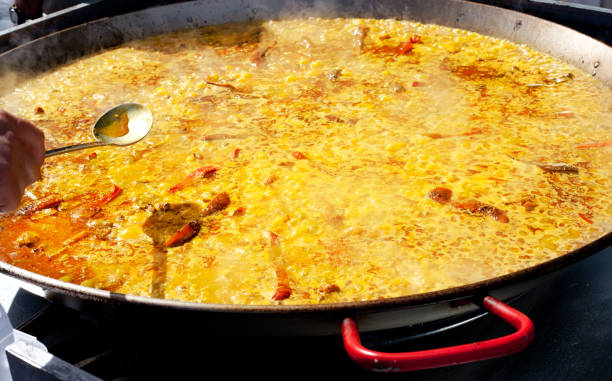 istock Paella rice from Valencia Spain cooking in big pan 1338058192