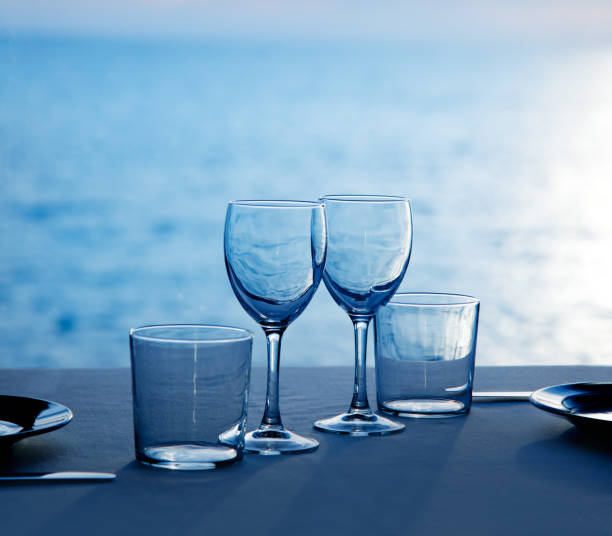 istock Glass dish cups and glasses on blue sea 1338058706