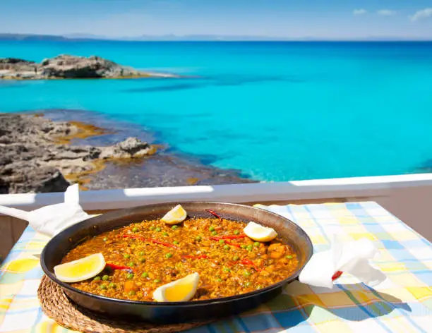 Paella mediterranean rice food by the Balearic Formentera island beach
