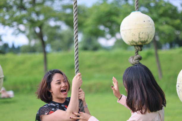 istock Young Asian students enjoying swing at park 1338059204