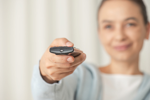 Woman looking the tv at home.