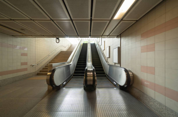 istock Empty modern escalator at subway station. Electric system moving staircase. Floor and step level. Transportation in underground. 1338059640