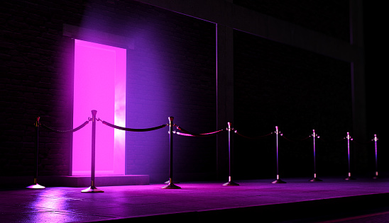 An evening scene outside a nightclub entrance emitting a pink light and an empty queue demarcated with barrier posts and rope - 3D render