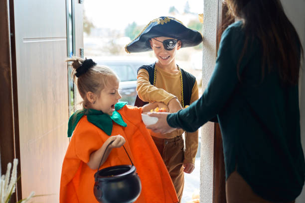 istock Children dressed in Halloween Costumes trick-or-treating 1338060469