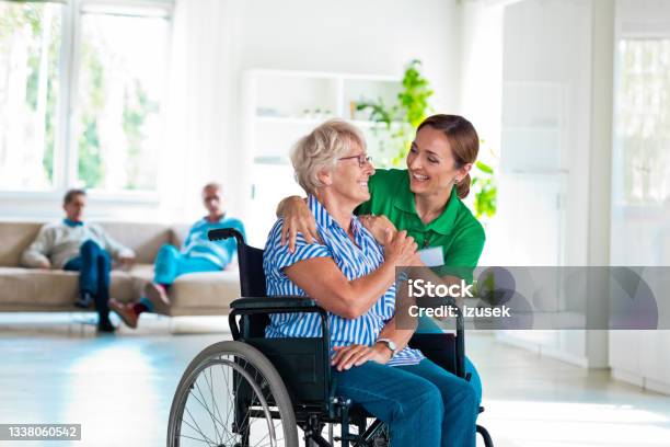 Senior Woman Talking With Nurse In Retirement House Stock Photo - Download Image Now