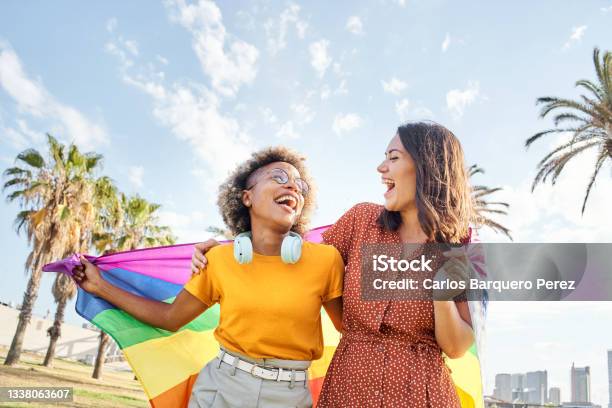 Lesbian Loving Couple Looking At Each Other With Rainbow Flag Concept Of Pride Homosexual Equality Freedom Stock Photo - Download Image Now