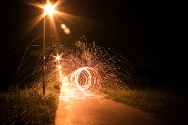 A long exposure photo of gold fairy lights in the dark