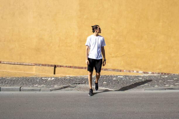 istock a young man crossing the street 1338066330