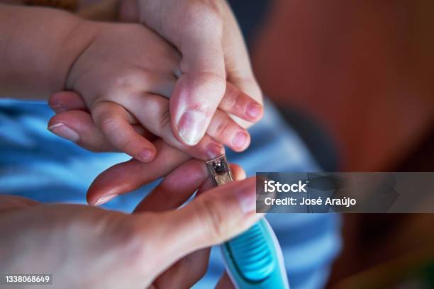 Mother Cutting The Babys Fingernails Stock Photo - Download Image Now - Adult, Adults Only, Close-up