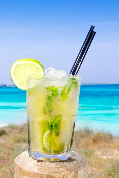 istock Cocktail mojito ice lemon straws in tropical beach 1338069246