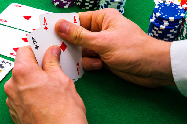A man shows his deck of aces during a poker game, stock photo