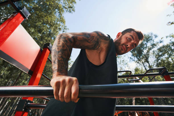 istock Calm tattoed bodybuilder doing push ups outdoors 1338069674