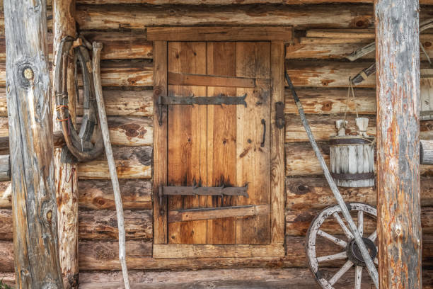 The entrance door to the old wooden village bathhouse. The entrance door to the old wooden village bathhouse. Vintage image of a rustic lifestyle. barn doors stock pictures, royalty-free photos & images