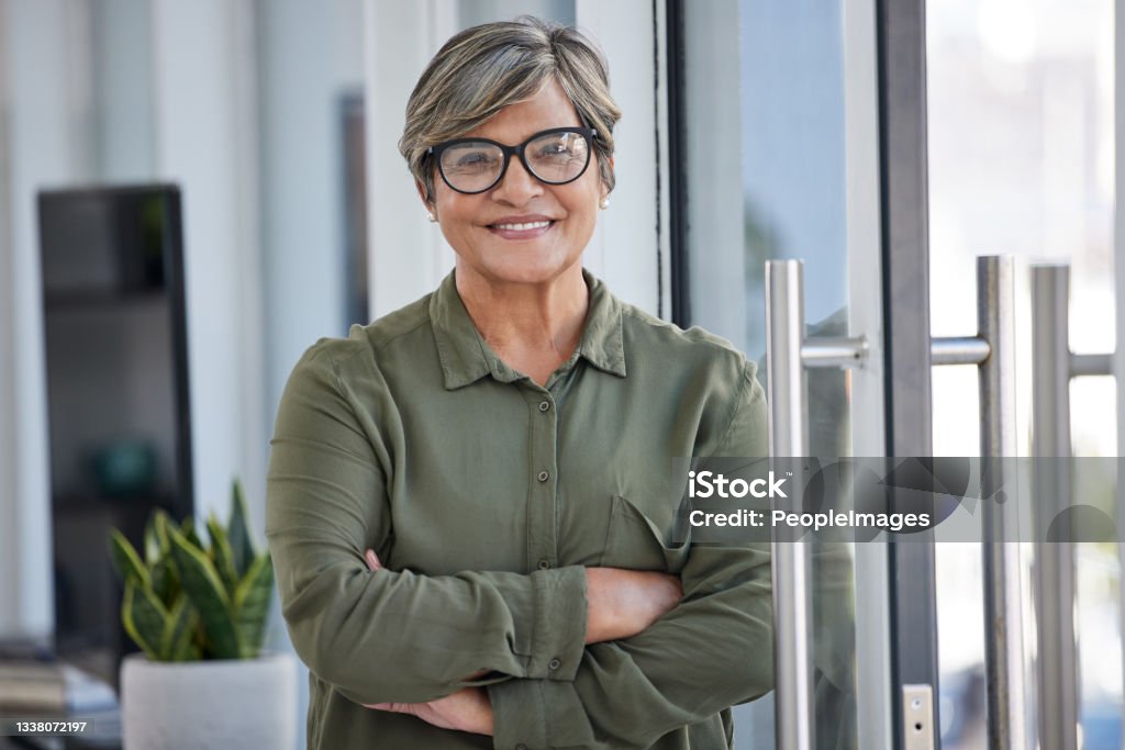 Shot of a businesswoman in her office Proud of how far I've come Women Stock Photo
