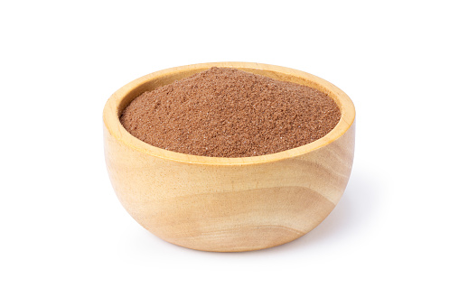 Cocoa powder in wooden bowl isolated on white background. Clipping path.