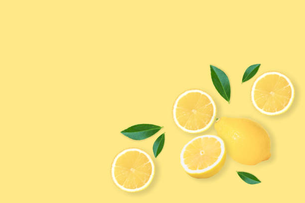 istock lemon fruit with slice and green leaves isolated on yellow background . 1338075832