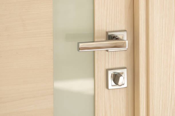 istock Modern door with a glass stripe with a nickel-plated handle and a latch 1338076024