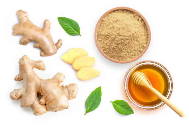 Ginger and honey Fresh Ginger rhizome and ginger powder in wooden bowl with mint green leaves and honey isolated on white background. Top view. Flat lay. ginger spice stock pictures, royalty-free photos & images