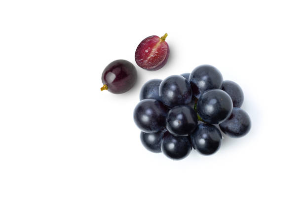 Black grapes fruit and half sliced isolated on white background Black grapes fruit and half sliced isolated on white background. Top view. Flat lay. grape stock pictures, royalty-free photos & images