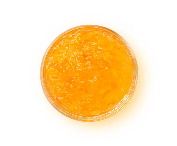 istock Orange jam in glass bowl isolated on white 1338078541