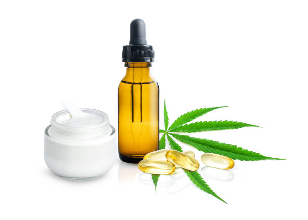 Cannabis hemp essential CBD oil and capsules Cannabis hemp essential CBD oil extract and capsules with fresh organic marijuana green leaf isolated on white background. cbd oil photos stock pictures, royalty-free photos & images