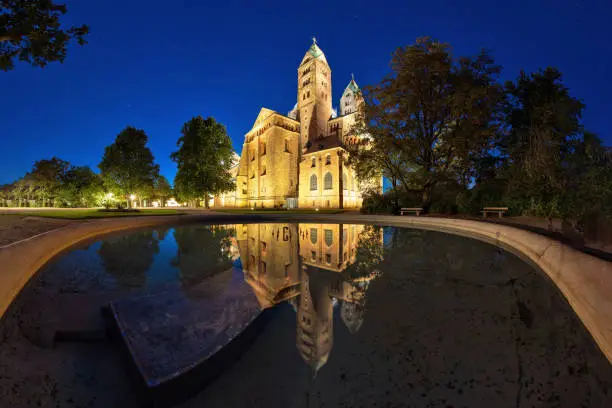 a very special view of Speyer Cathedral in the blue hour with reflection in a fountain