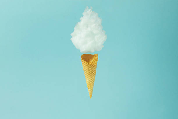 istock Cloud in a flying ice cream cone on the soft blue background. Minimal concept. 1338083840
