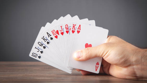 istock Male hand holding playing cards. 1338085356