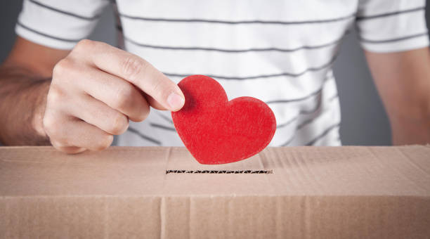 istock Male hand putting red heart in box. 1338085366