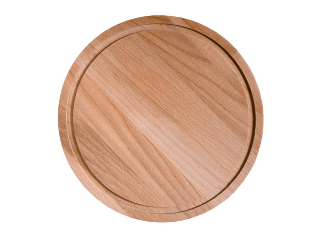 istock Wooden round cutting board on wooden table, copy space 1338085578