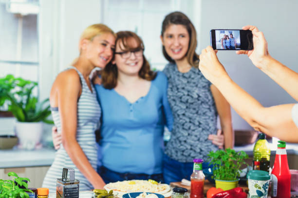 istock Friends Preparing Pizza for a Dinner Party 1338086786