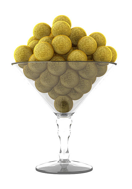round golden foiled chocolates in glass isolated on white background