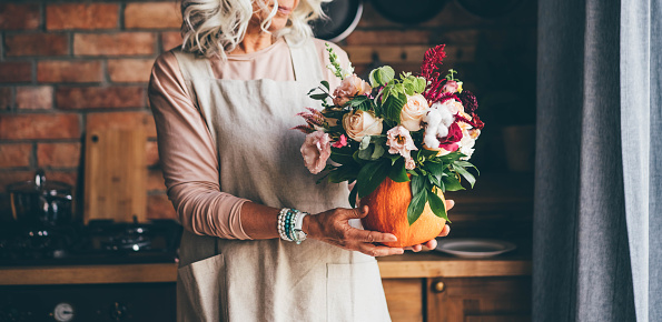 Pumpkin with beautiful bouquet on hand.