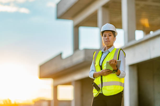 istock Portrait of young female engineer holding digital tablet on construction site 1338087993