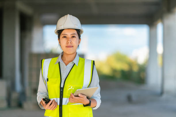 istock Portrait of young female engineer holding digital tablet on construction site 1338088074