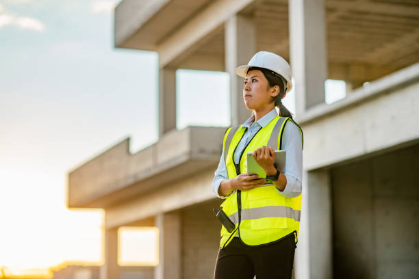 istock Portrait of young female engineer holding digital tablet on construction site 1338089707