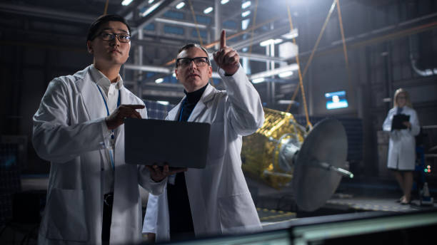 istock Engineer and Technician Working on Satellite Construction. Aerospace Agency: Diverse Team of Scientists Using Technological Equipment and Laptop Computer to Develop Spacecraft for Space Exploration. 1338090327