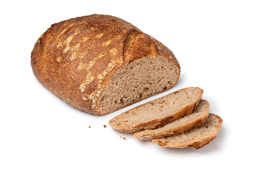 Sliced whole fresh baked German dinkel wheat bread on white background
