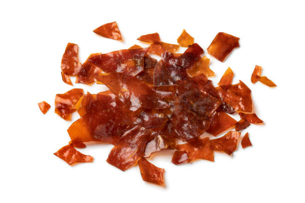 istock Heap of brown Shellac flakes on white background 1338091310